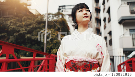 City, walking and Japanese woman with travel, bridge and thinking in urban town with fashion. Kimono, street and traditional clothes with outdoor on weekend in Tokyo for vacation with journey 120951919