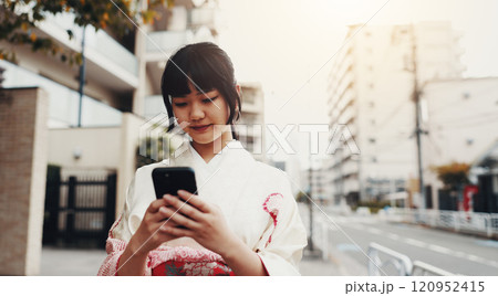 City, phone and Japanese woman with kimono, typing and connection for social media on morning commute. Travel, traditional clothes and girl in urban street on mobile app on smartphone for online chat City, phone and Japanese woman with kimono, typing and connection for social media on morning commute. Travel, traditional clothes and girl in urban street on mobile app on smartphone for online chat 120952415