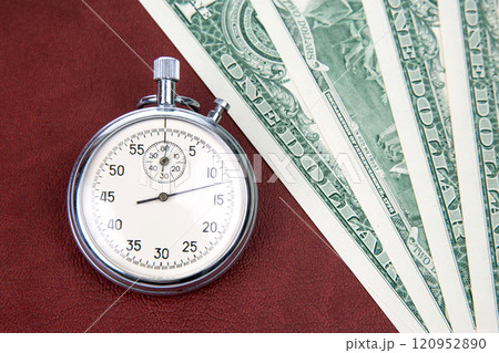 mechanical stopwatch on the background of dollars. Part time accuracy for business 120952890