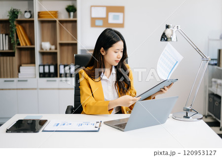 Business woman using tablet and laptop for doing math finance on an office desk, tax, report, accounting, statistics, 120953127