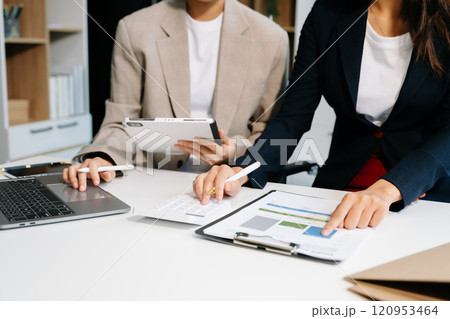 Businessman and team analyzing financial statement Finance task. with smart phone and laptop and  tablet. Wealth management concept 120953464