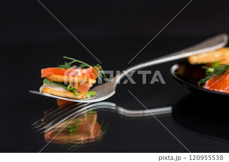 small snack canapes with crackers and lightly salted red fish Salmon, isolated on black background 120955538