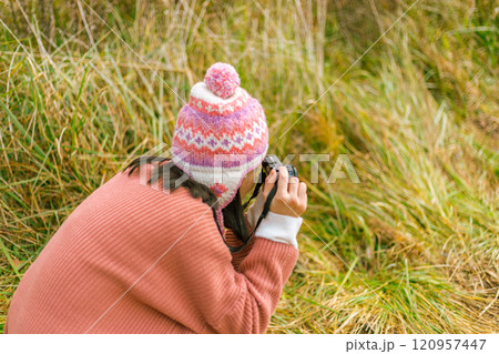 Woman taking nature photographs Woman taking nature photographs 120957447