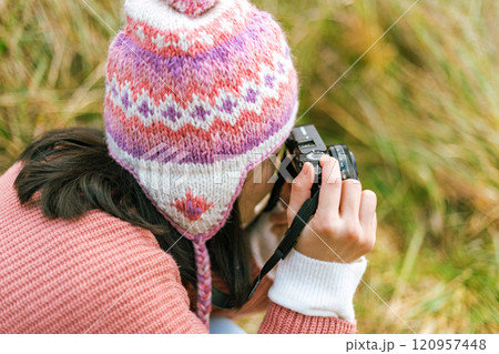 Woman taking nature photographs Woman taking nature photographs 120957448