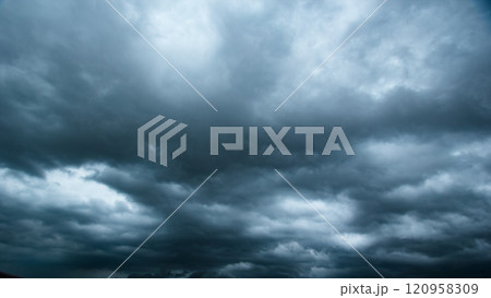 The dark sky with heavy clouds converging and a violent storm before the rain.Bad or moody weather sky and environment. carbon dioxide emissions, greenhouse effect, global warming, climate change. 120958309