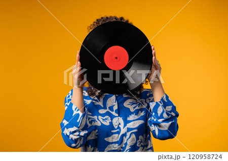 Young african teen or woman with vinyl record disc. Hobby,Music Lover,Collection 120958724