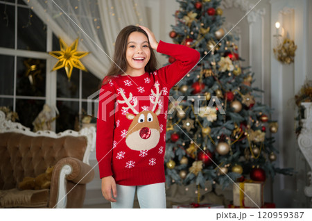 small happy girl at christmas. Christmas. Kid enjoy the holiday. Happy new year. morning before Xmas. New year holiday. little child girl likes xmas present. Christmas party time. favorite sweater 120959387