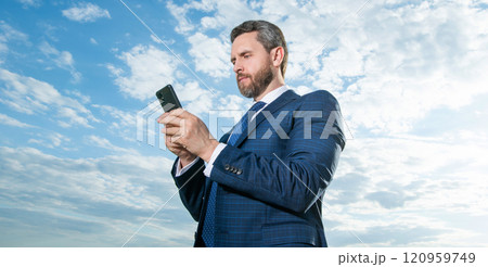 photo of businessman type phone message. businessman type phone message on sky background photo of businessman type phone message. businessman type phone message on sky background 120959749