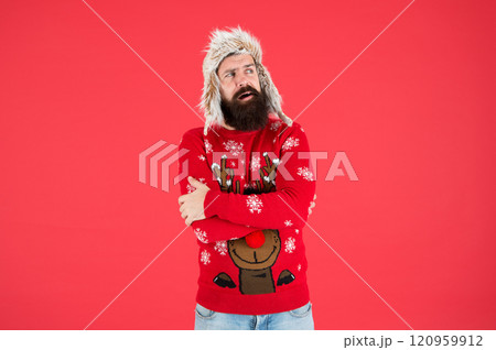 Stay warm in style. Bearded man feel cold red background. Hipster shiver of cold. Festive fashion trends for cold weather. Holiday season. Keeping cold out 120959912