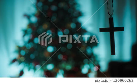 Silhouette Christian Crucifix In Front Of Christmas Tree Turned Off At Night Silhouette Christian Crucifix In Front Of Christmas Tree Turned Off At Night 120960262