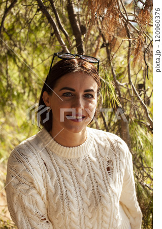 young brunette woman outside in green park sunny day, lifestyle people concept close up 120960376