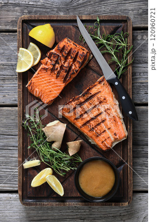 grilled salmon fish fillet with herbs, top view grilled salmon fish fillet with herbs, top view 120960721