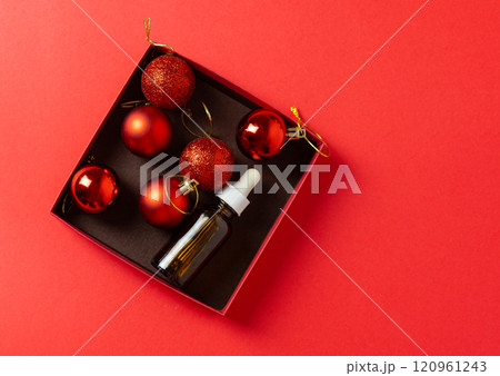 red christmas baubles in box with serum bottle, cosmetic container red christmas baubles in box with serum bottle, cosmetic container 120961243