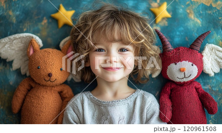cheerful child looks directly viewer angel one shoulder and playful devil other. vibrant background adds joyful touch perfect children’s stories. 120961508