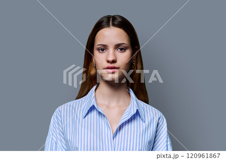 Headshot portrait of young serious red-haired teenage girl on gray background Headshot portrait of young serious red-haired teenage girl on gray background 120961867