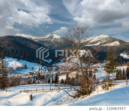 Winter  morning mountain village outskirts and alp ridge 120963957