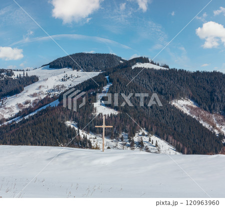 Cross on winter mountain hill top 120963960