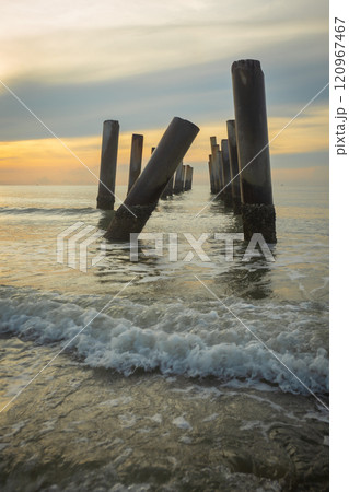 A beautiful sunrise at old leaning cement pillars Cha-Am beach, Phetchaburi, Thailand. A beautiful sunrise at old leaning cement pillars Cha-Am beach, Phetchaburi, Thailand. 120967467
