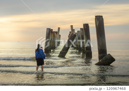 A beautiful sunrise at old leaning cement pillars Cha-Am beach, Phetchaburi, Thailand. A beautiful sunrise at old leaning cement pillars Cha-Am beach, Phetchaburi, Thailand. 120967468