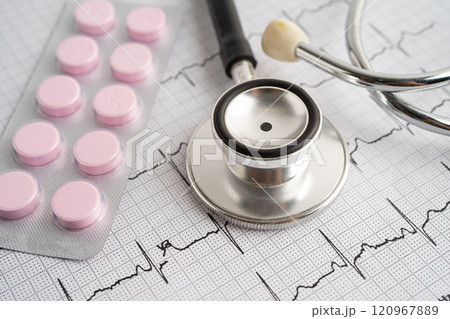 Stethoscope on electrocardiogram ECG with capsule drug, heart wave, heart attack, cardiogram report. 120967889