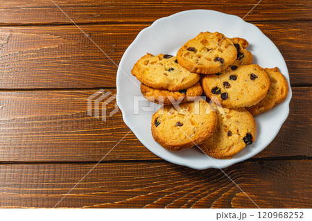 Delicious homemade Christmas cookies with raisins on a white plate 120968252