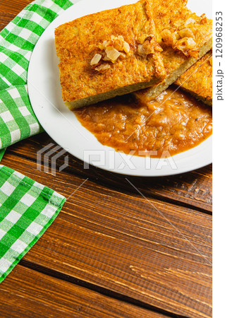 Oven-baked potato pancakes with mushroom sauce and onions 120968253