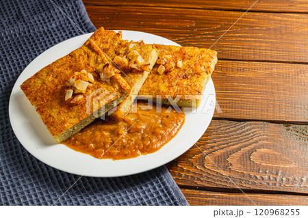 Oven-baked potato pancakes with mushroom sauce and onions 120968255