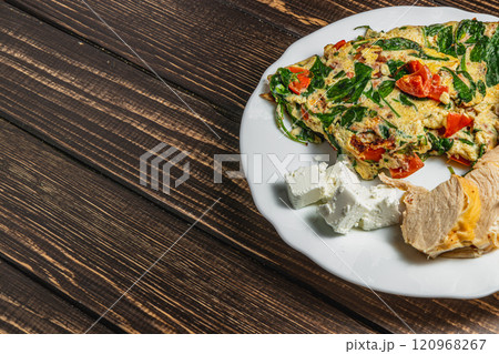 Hot breakfast of eggs, fresh vegetables, delicious chicken and tender cheese Hot breakfast of eggs, fresh vegetables, delicious chicken and tender cheese 120968267