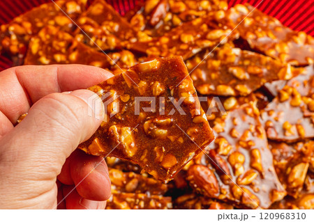 Homemade sugar cookies with nuts in a man's hand with a blurred background 120968310