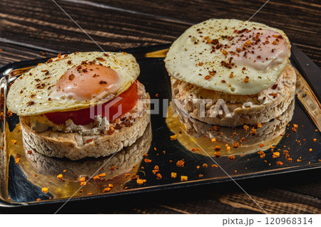 egg sandwiches on rice bread with tomato and cheese on a metal plate egg sandwiches on rice bread with tomato and cheese on a metal plate 120968314