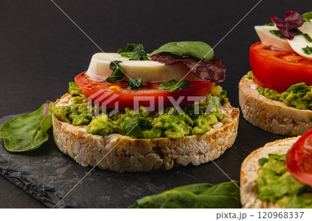 Vegan food concept, rice cakes with fresh vegetables on black background 120968337