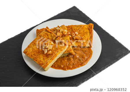 Oven-baked potato pancakes with mushroom sauce and onions on a stone board 120968352