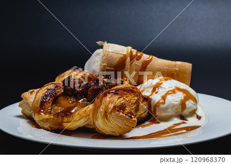 Delicate puff pastry with apples, ice cream and caramel syrup, snack concept Delicate puff pastry with apples, ice cream and caramel syrup, snack concept 120968370