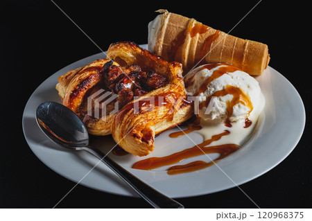 Homemade puff pastry with apple and ice cream, drizzled with caramel sauce Homemade puff pastry with apple and ice cream, drizzled with caramel sauce 120968375
