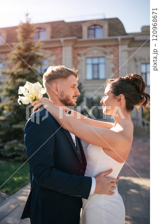 Portrait of a beautiful groom and a bride. outdoors 120968671