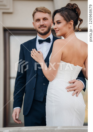 Happy and in love bride and groom on the balcony at the railing at the entrance  120968679