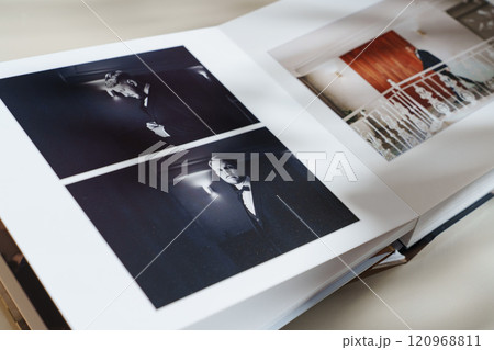 page of an open photo book with wedding photos on a white table page of an open photo book with wedding photos on a white table 120968811