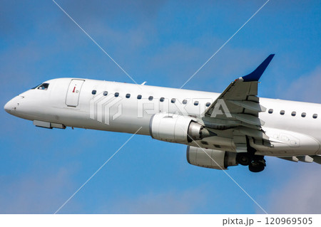 Close-up white passenger airplane in the air on take-off 120969505