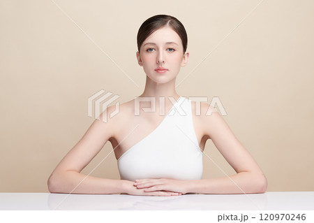 Beautiful young woman with clean fresh skin on beige background, Face care, Facial treatment, Cosmetology, beauty and spa, women portrait. Beautiful young woman with clean fresh skin on beige background, Face care, Facial treatment, Cosmetology, beauty and spa, women portrait. 120970246