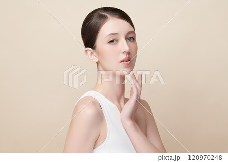 Beautiful young woman with clean fresh skin on beige background, Face care, Facial treatment, Cosmetology, beauty and spa, women portrait. Beautiful young woman with clean fresh skin on beige background, Face care, Facial treatment, Cosmetology, beauty and spa, women portrait. 120970248