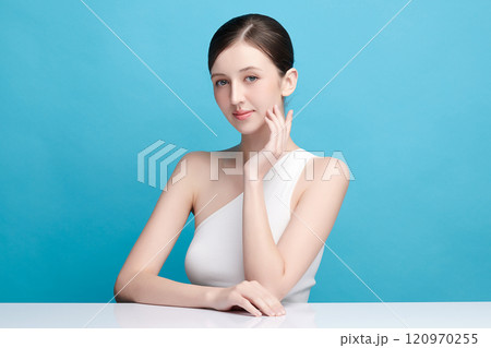 Beautiful young woman with clean fresh skin on blue background, Face care, Facial treatment, Cosmetology, beauty and spa, women portrait. 120970255