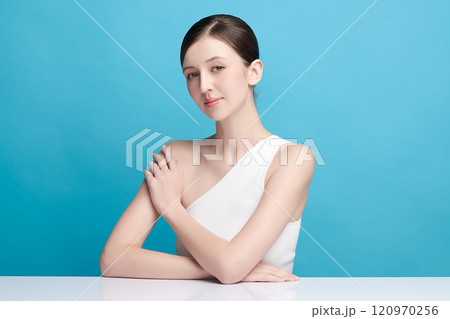 Beautiful young woman with clean fresh skin on blue background, Face care, Facial treatment, Cosmetology, beauty and spa, women portrait. 120970256