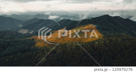 Mountains and fields of yellow flowers in the evening 120970276