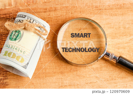 The concept of technology and development. Phrase, words, text SMART TECHNOLOGY through a magnifying glass on an antique background, top view The concept of technology and development. Phrase, words, text SMART TECHNOLOGY through a magnifying glass on an antique background, top view 120970609