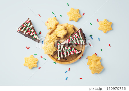 Christmas tree chocolate brownies and cookies in wooden tray on light blue background Christmas tree chocolate brownies and cookies in wooden tray on light blue background 120970736
