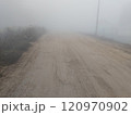 Dirt road in rural on a heavy foggy day 120970902