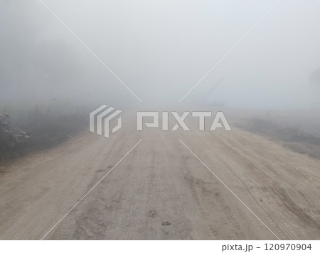 Dirt road in rural on a heavy foggy day 120970904