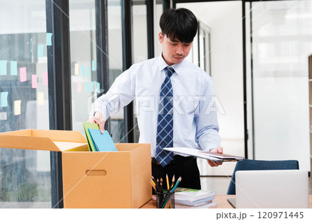 Employee packing belongings into a box during a job change or resignation 120971445