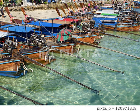A vibrant, picturesque beach scene showcasing colorful boats 120971819