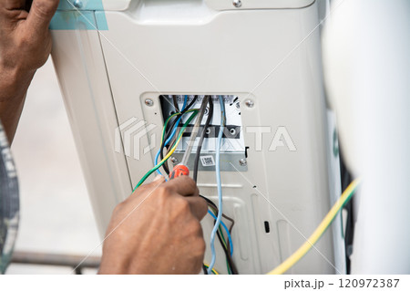 Technician  install  air conditioner outdoor unit 120972387